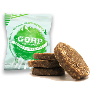 Peanut Butter & Apple GORP Clean Energy Bar, package with green GORP World logo.  Three bars piled up with one resting on the right side, showing the ingredients in the bar. 65g bar